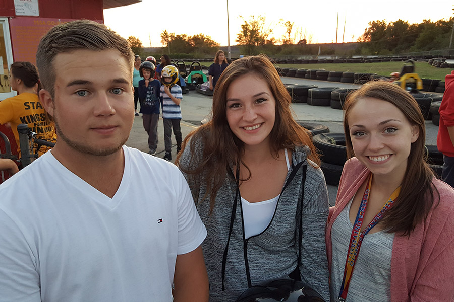 three students at a go kart track