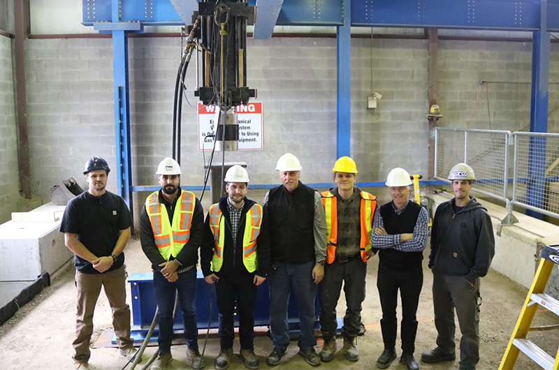 A project team and sponsors pose after using the unique Culvert Testing Facility in the GeoEngineering Laboratory