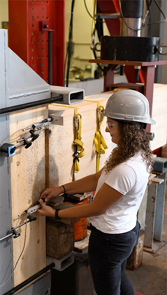 A researcher tests a new connection design for glued laminated timber (glulam) for seismic resistance